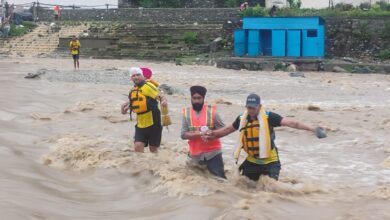 SDRF personnel rescue stranded pilgrims from a swollen river during the Reetha Sahib Jod Mela in Champawat, Uttarakhand.