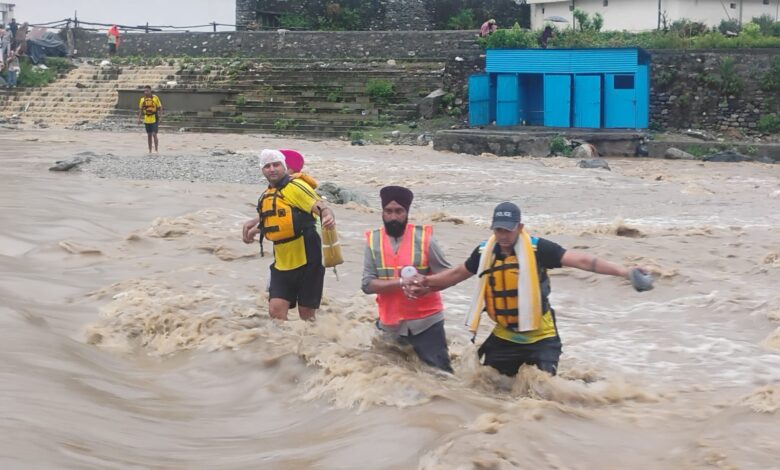 SDRF personnel rescue stranded pilgrims from a swollen river during the Reetha Sahib Jod Mela in Champawat, Uttarakhand.